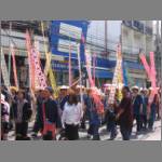 Parade participants carry many banners